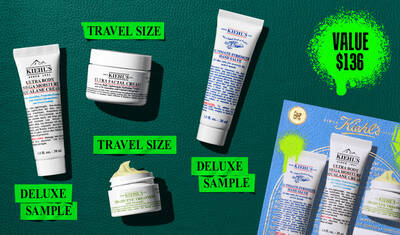 A graphic, set against a dark green textured background, features four Kiehl’s products and a gift box. A white tube of "KIEHL’S ULTRA BODY MEGA MOISTURE SQUALANE CREAM" is labeled "DELUXE SAMPLE" in bright green. A white jar of "KIEHL’S ULTRA FACIAL CREAM" is labeled "TRAVEL SIZE" in bright green. A white tube of "KIEHL’S ULTIMATE STRENGTH HAND SALVE" is labeled "DELUXE SAMPLE" in bright green. A small open white jar of "KIEHL’S CREAMY EYE TREATMENT WITH AVOCADO" with visible pale yellow cream is labeled "TRAVEL SIZE" in bright green. In the lower right, a blue Kiehl’s gift box showcasing the same four products is visible, decorated with bright green graphic paint splatters and a bow design