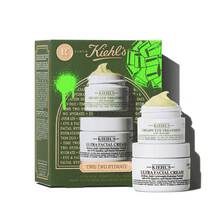 A Kiehl's green gift box is shown on the left, with "TIME TWO HYDRATE" text, and green graphic elements. To the right, two jars of products are stacked: the top jar is "KIEHL'S CREAMY EYE TREATMENT with avocado" and has a visible yellow-green swirl of product on top. The bottom jar is "KIEHL'S ULTRA FACIAL CREAM".